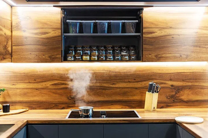 Herbs and spices are stored above the cooktop.