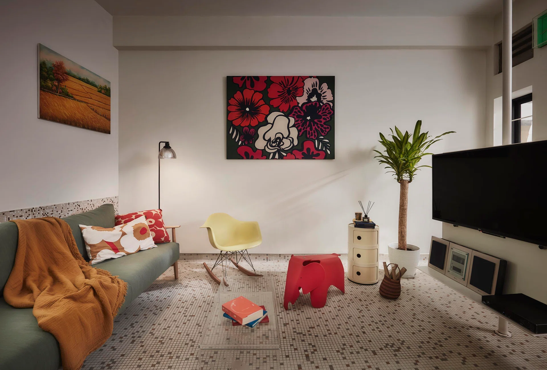 Original mosaic flooring runs through the home, providing a lively, textured base for the homeowners’ long-collected furniture, artwork, and everyday objects.