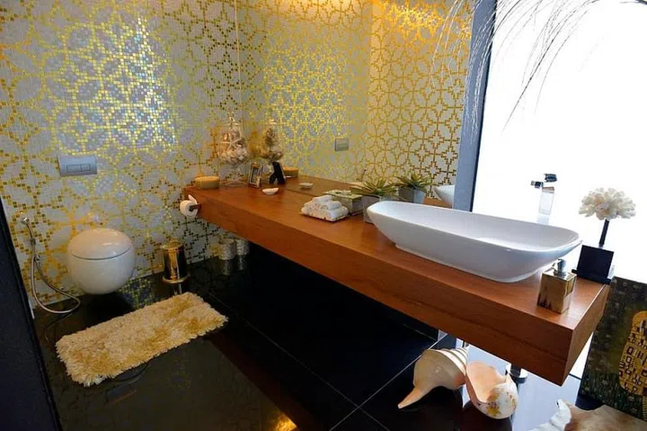 Bisazza white and 22K gold tiles adorn the swimming pool bathroom.