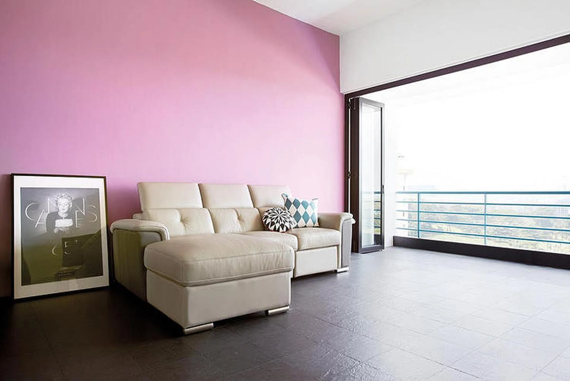Lilac paint is applied to one wall of the living room, bringing a fun, warm feel to the space. Cushions from The Design Store.