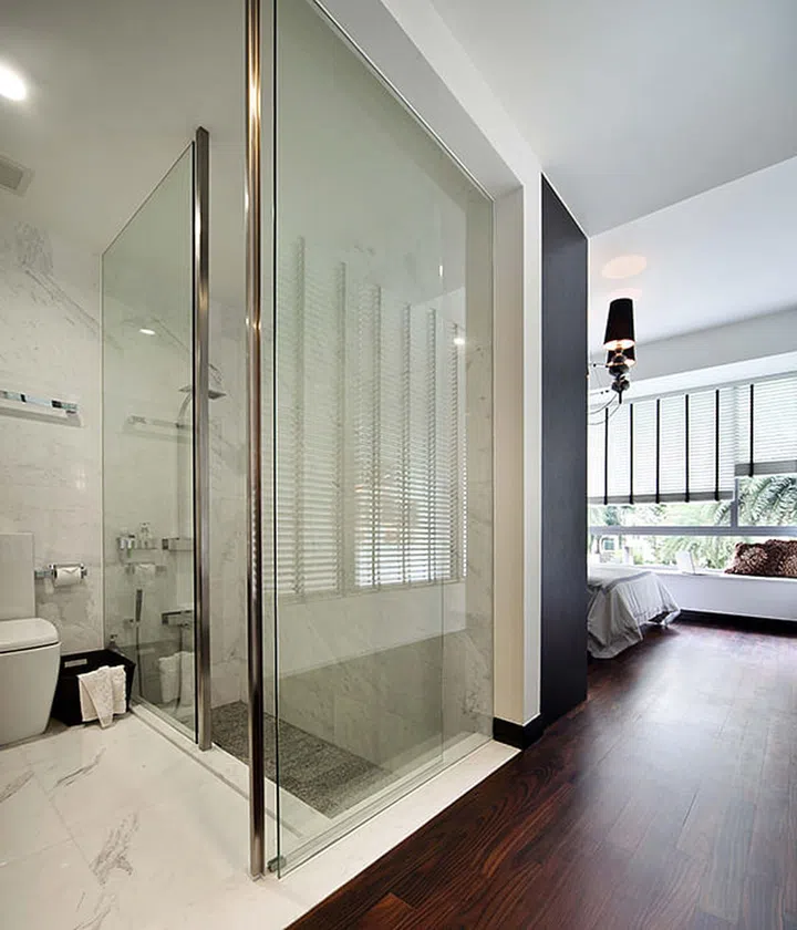 Glass walls with stainless steel trimmings for this marble bathroom. Interior design by The Scientist