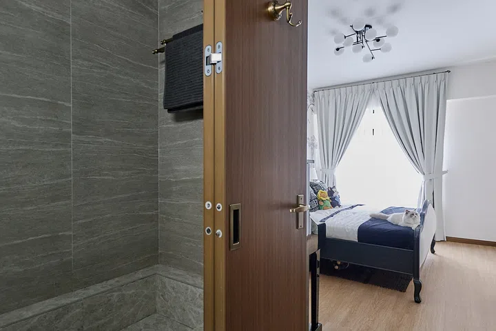 The ensuite opens directly off the master bedroom, continuing its warm, restrained palette.