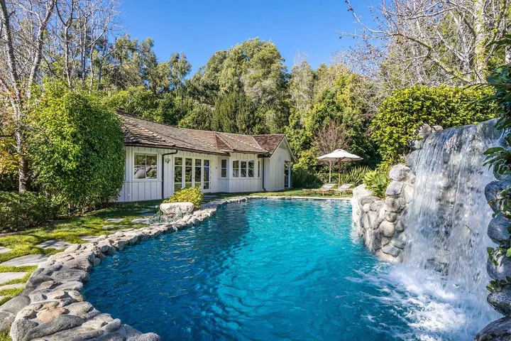 The two-acre lot includes a spectacular waterfall pool.