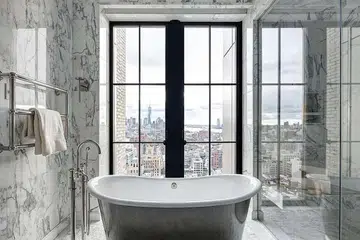 Large windows and less privacy are among the trends in bathroom design, as seen in this one in Walker Tower in New York.PHOTO: NYTIMES