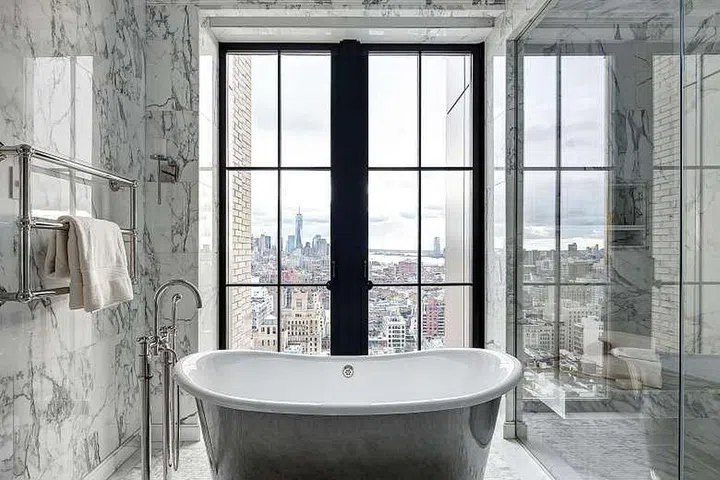 Large windows and less privacy are among the trends in bathroom design, as seen in this one in Walker Tower in New York.PHOTO: NYTIMES