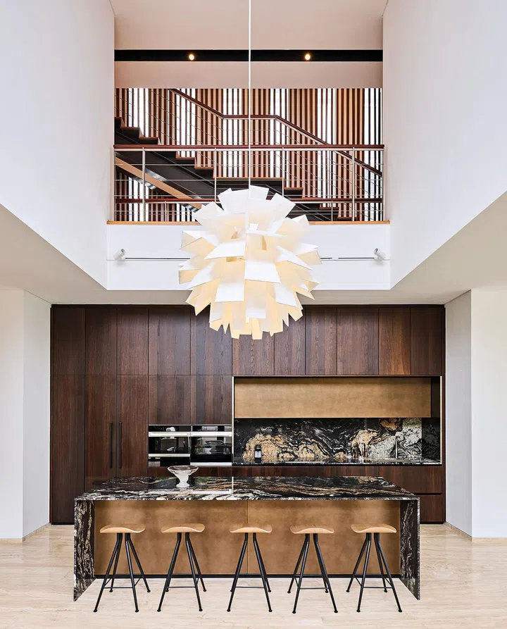 The double- volume ceiling height creates an impressive feel above the headturning kitchen counter.