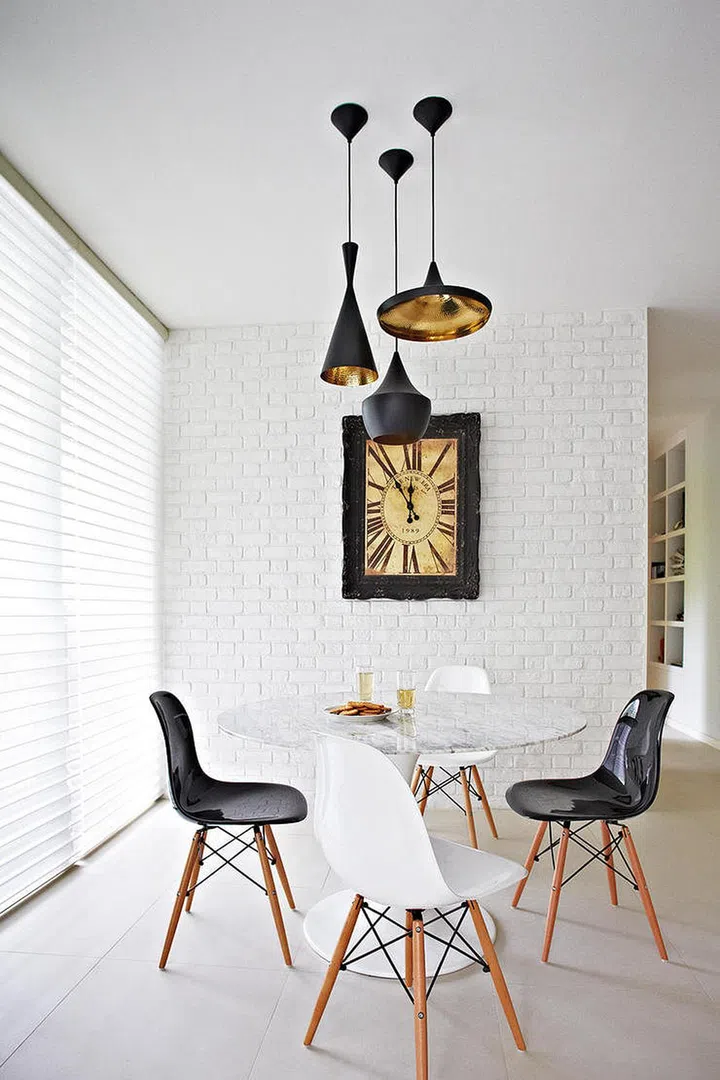 To jazz up an understated room furnished with streamlined furniture, clad one wall with whitewashed bricks to add subtle textures with an elegant simplicity. Interior design by Black N White House