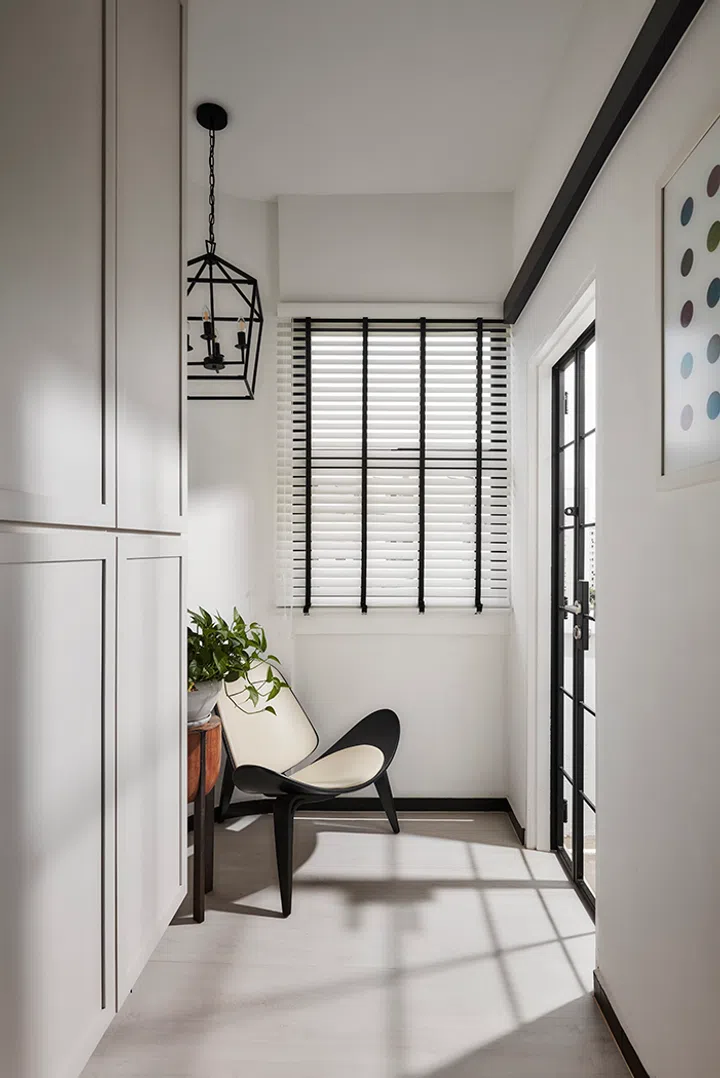 A wooden armchair sets the scene for what's to come beyond the elegantly-clad entrance foyer. 