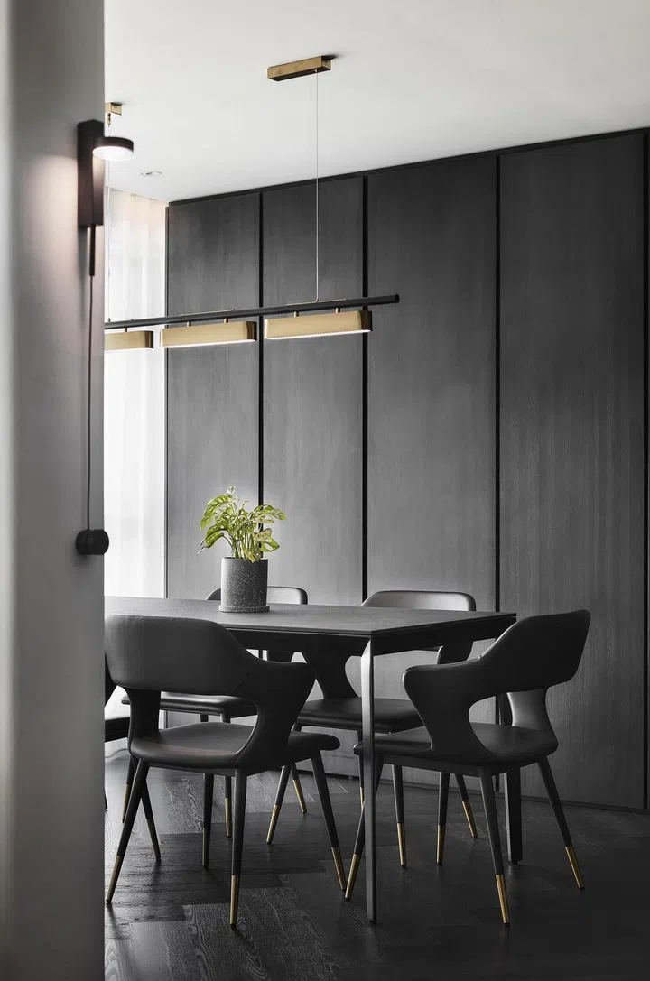 A row of full-height, built-in cabinets line the walls of the dining room in this 4-room Punggol HDB.