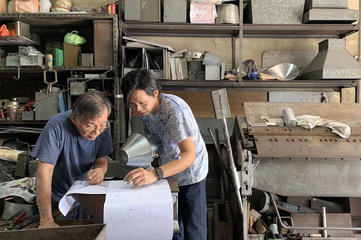 Studio Juju's Co-founder Timo Wong discussing with local tinsmith to produce their Galvanic Lamp. Credit: Studio Juju