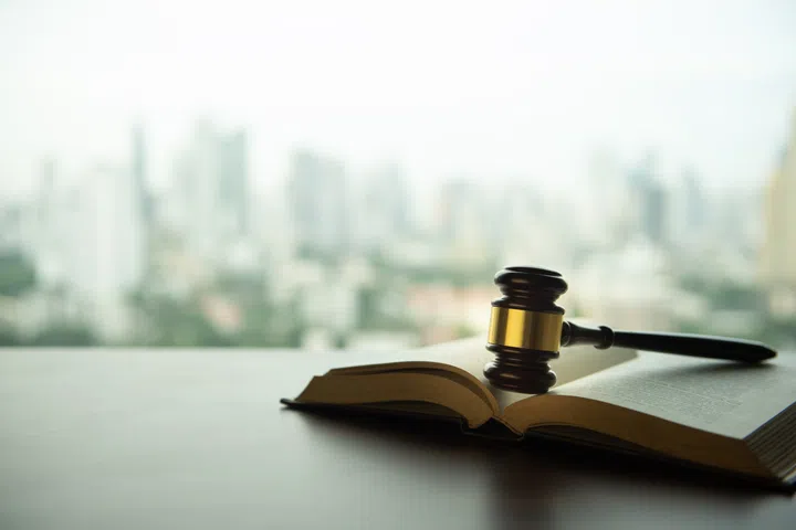 auction hammer or judge gavel with law books on legal desk with copy space.
