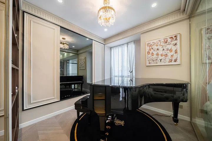 The home features hallmarks of Rococo-style interior designs, including marbled surfaces and dripping crystal chandeliers.