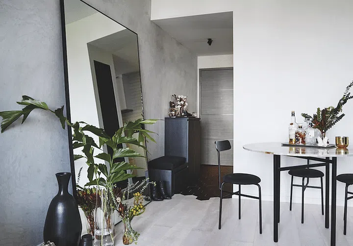 Concrete on the walls and whitewashed engineered wood for the floors that continue from the living room to the bedroom