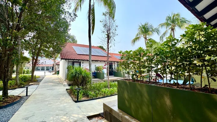 Greenery and a communal courtyard replace the previous open barbeque pit setup.