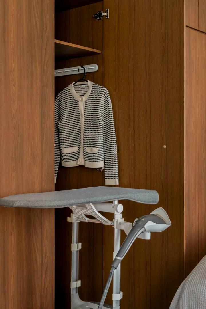 Even the ironing board folds away into built-in storage—proof of the home’s space efficiency.