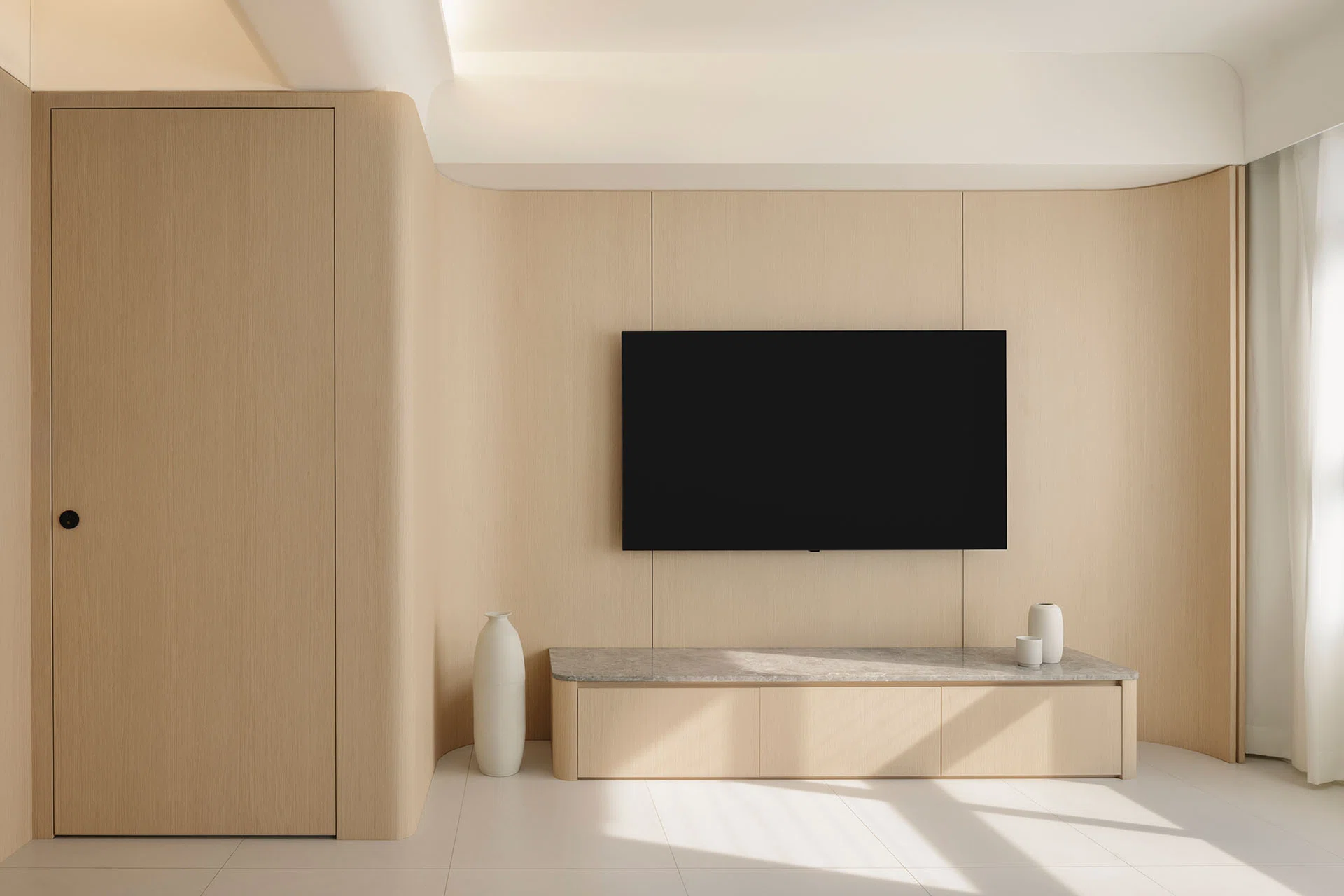 Curved wall corners soften the living room in a 4-room HDB in Punggol.