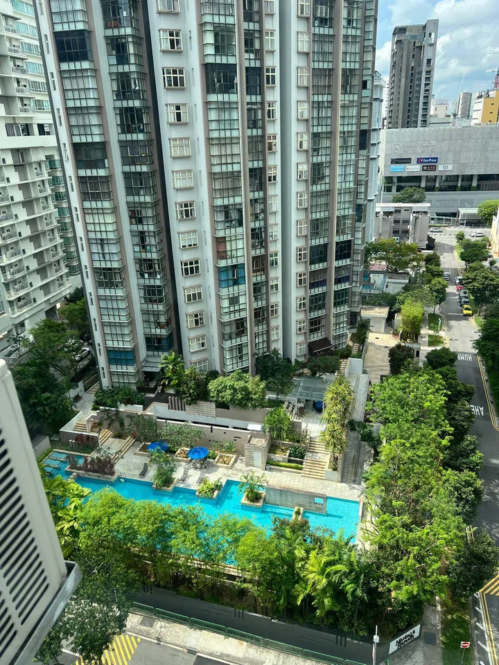The view from Candy’s current Singapore apartment, overlooking the next-door condo with its on-site pool facilities.