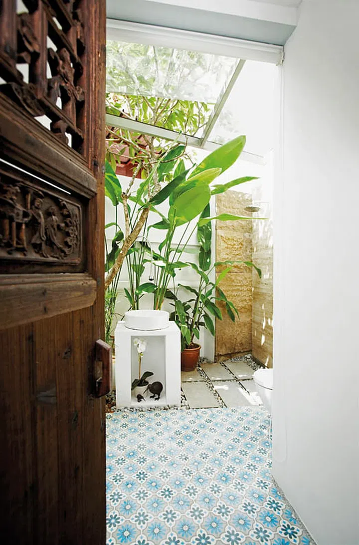 The shophouse-design typology is given a casual twist with whimsical bird figures and a tap hanging off a tree branch. Flower pot from AF Home; kiwi figurines from John Erdos Home. (Reno: $250K excluding furniture)