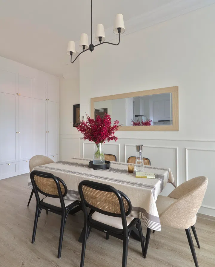 The dining area exudes a chic coastal feel, with classic yet modern design. 