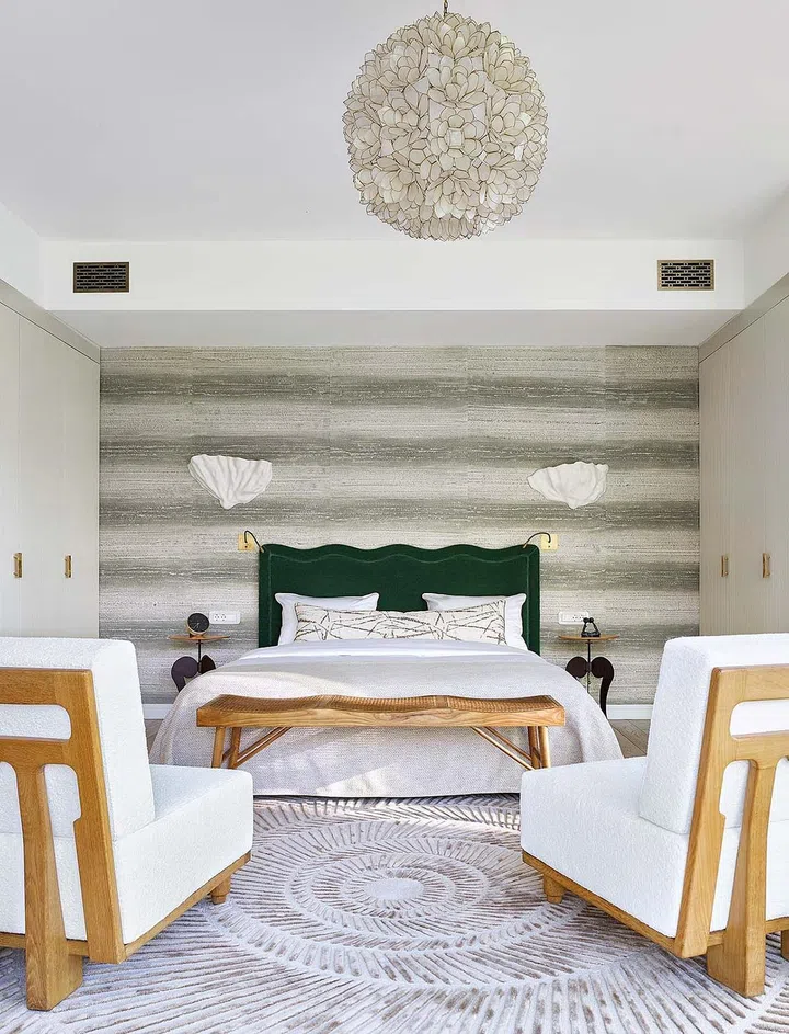Scalloped edges, seashell vintage pendant light and carpet with spiral motif from M Carpet Atelier are subtle nods to the marine life theme.