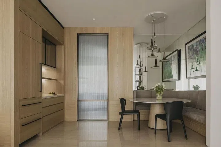Occupying what was formerly the dry kitchen is now a dining area, concealed fridge and pantry. (Photo: Studio Periphery)