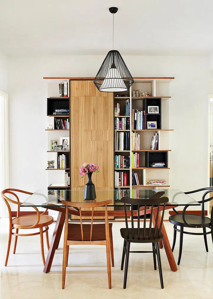 Use a sliding wooden panel to create a storage-display dining unit which will match your other furniture. Interior design by Story of Us.