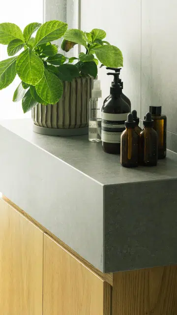 Closeup of stone and wood materials in the bathroom of this 1,900 sq ft 3-bedroom condominium in Sentosa.