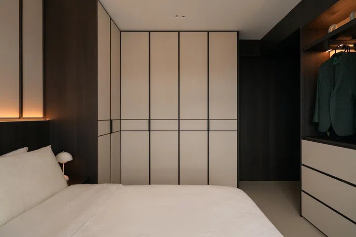 The bespoke wardrobes were detailed to sit almost flush with the ceiling and adjoining walls, giving them a more architectural presence while visually elongating the room.