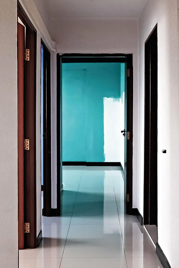 A long hallway leading to the bedrooms and looking into the master bedroom.