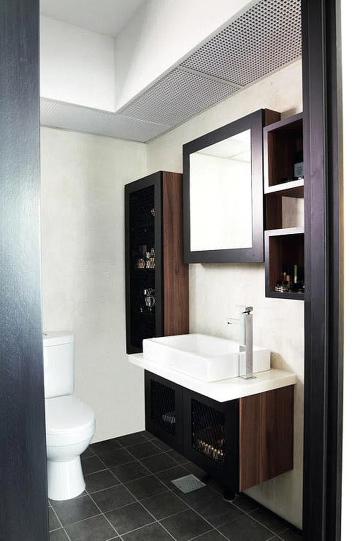 The easiest, and most seamless, way to incorporate storage into your bathroom is to have cabinets behind the mirror. Interior design by Space Sense Studio