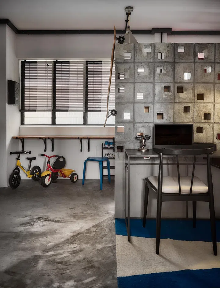 In front of the privacy wall is a small desk area, like a little office space.