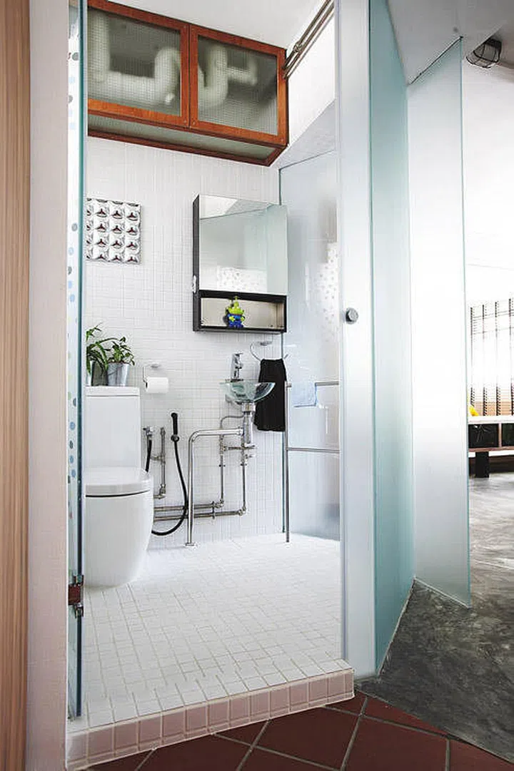 Simple white and wood minimalist bathroom with glass bi-fold doors. Interior Design by Urban Design & Build