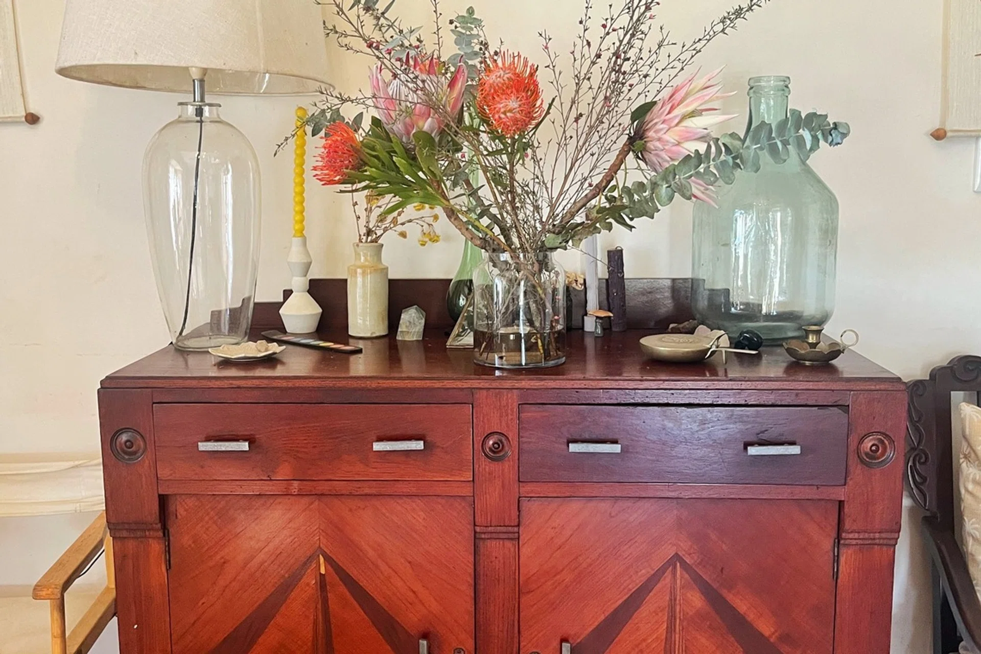 A Mid-Century Modern sideboard in my home, where dinner and servingware are stored away in an open-plan dining and living area