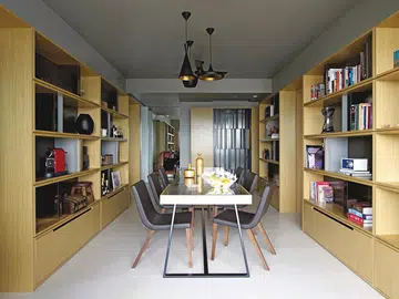 Open shelves house Asian art, architecture miniatures and other collectibles. Vases from Oddjects; fruitbowl from Alessi in this bachelor's condominium in Novena.