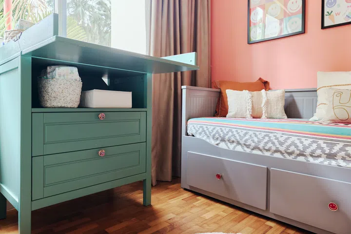 Originally a standard white IKEA changing table, this piece was repainted sage green and fitted with new knobs by  Lotte, reflecting her love of affordable DIY furniture hacks.