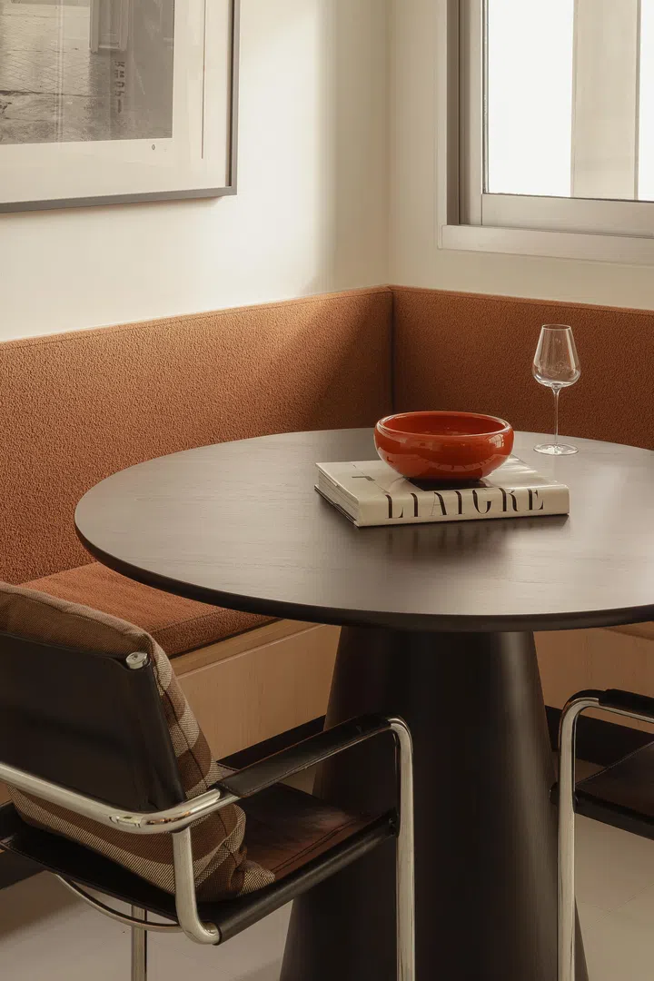 A circular table and compact seating make the space feel intimate yet adaptable.
