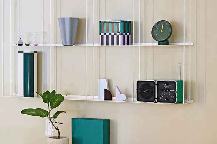Bright and colourful Scandinavian-style study corner with hanging open shelves.