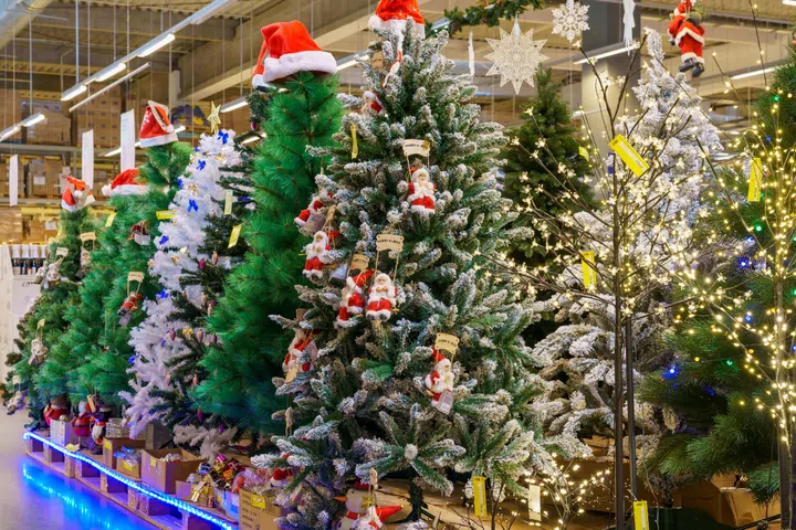 Artificial Christmas trees and symbols of the new year in the store. Background with copy space for text. Illustrative editorial. December 18, 2021 Balti Moldova.