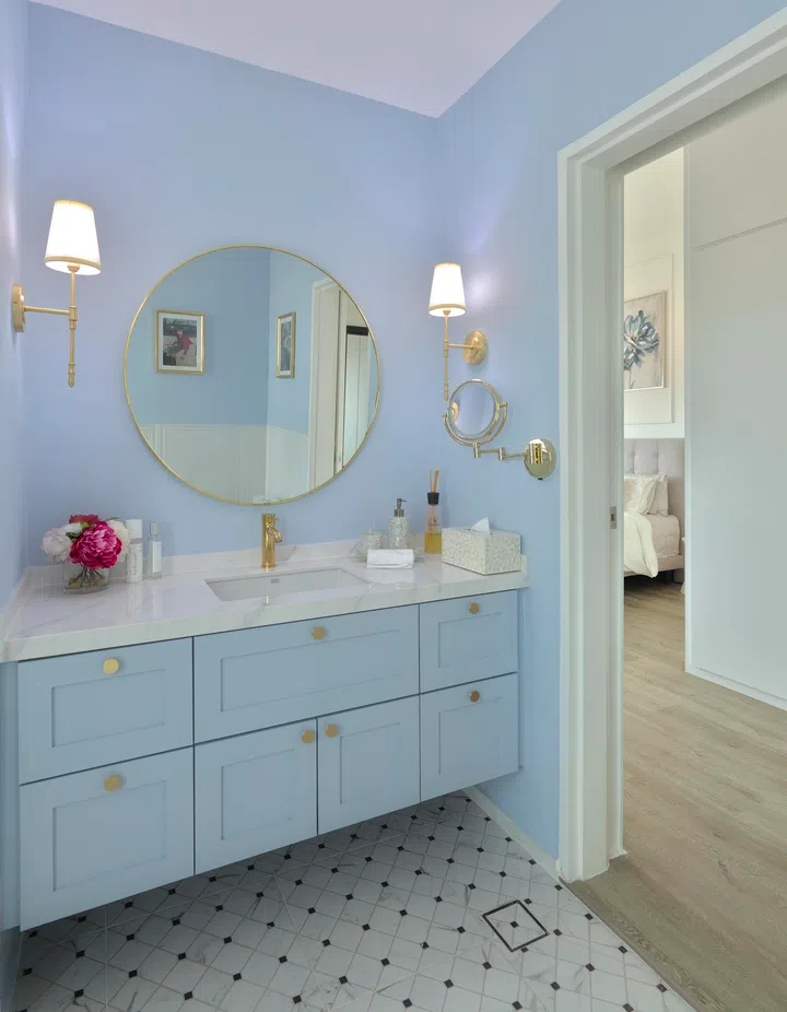She also brought in blue hues in the bathroom with wall paint (Lake Placid from Benjamin Moore), and vanity cabinet laminates done in Sky Grey. 