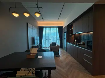 Overview of Quincy House's Two-Bedroom Deluxe living room and kitchenette spaces.