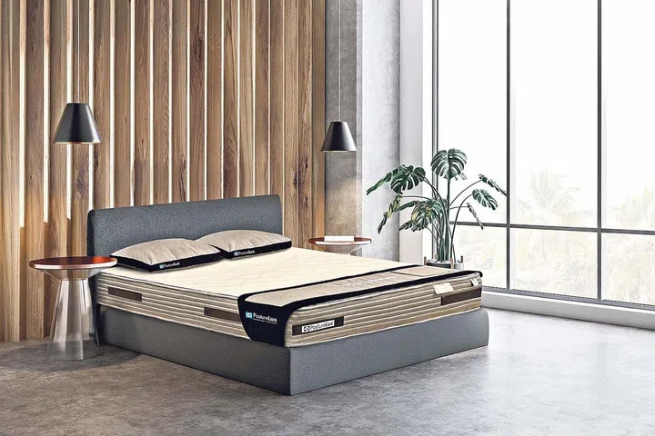 Corner of master bedroom with concrete and wooden walls, concrete floor, double bed with two bedside tables, potted plant and stylish lamps. 3d rendering