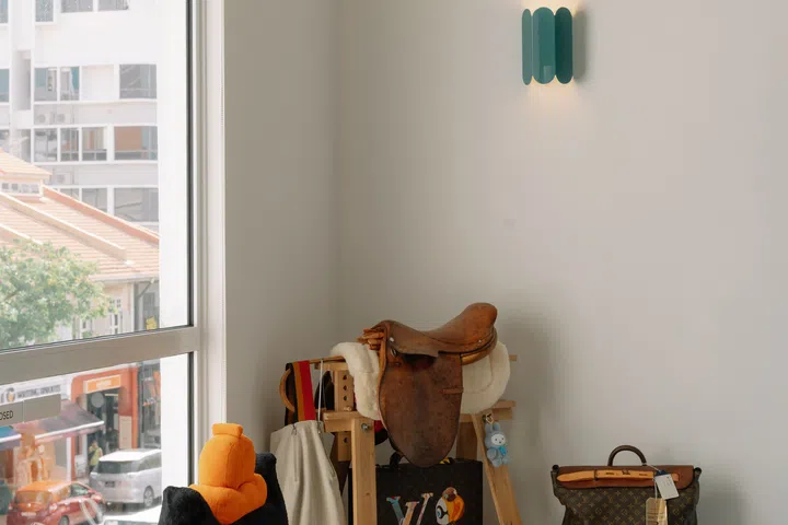 Flooded with natural light, the picture window creates a calm retreat overlooking the bustling streets below—a favourite spot for the couple and their two resident cats.