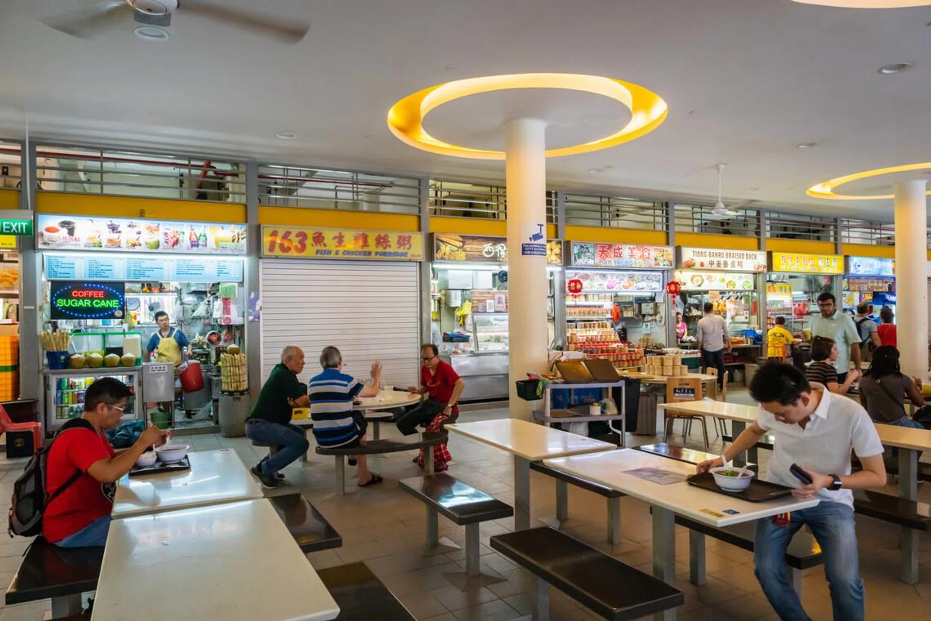 Singapore - January 2019: Street food stalls in hawker center in Singapore central area. Hawker centers are inexpensive open-air food courts popular in Singapore.