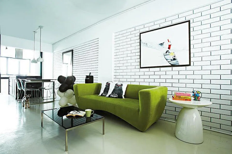 A pop of green in the living room injects life into the monochrome scheme.