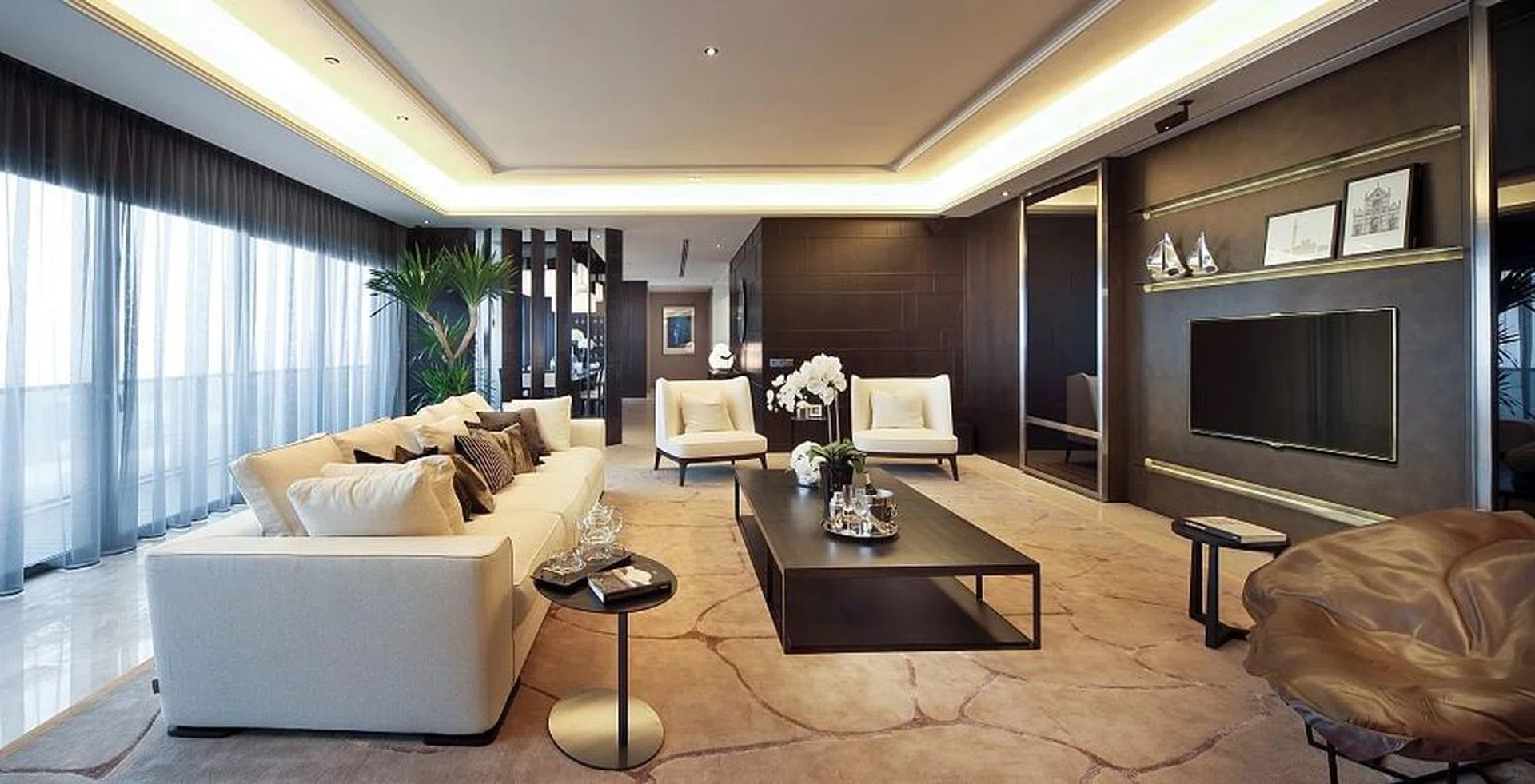 The living room of this home in the Soleil @ Sinaran Drive Condominium in Novena is anchored with a large rug and a cove ceiling design.