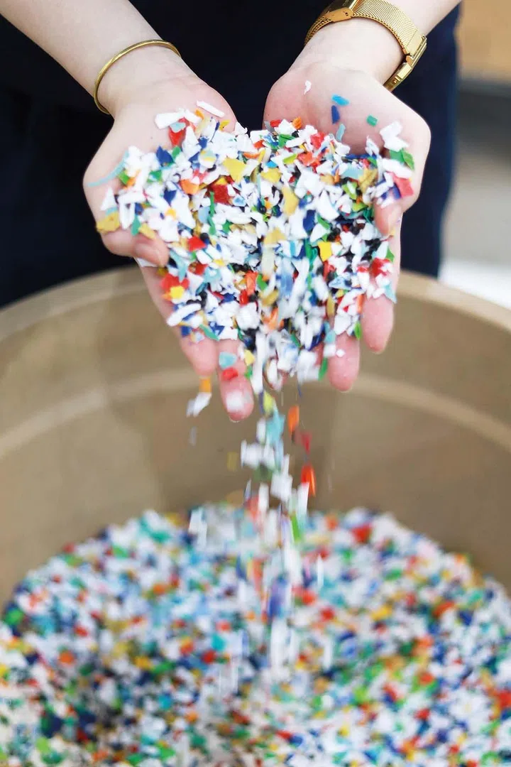 Recyclable plastic materials are painstakingly sorted, cleaned and processed into raw material for the creation of Karyn’s tables.