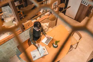 From above, the compact dining area doubles as a work surface—a reminder that every corner must earn its keep in a small home.