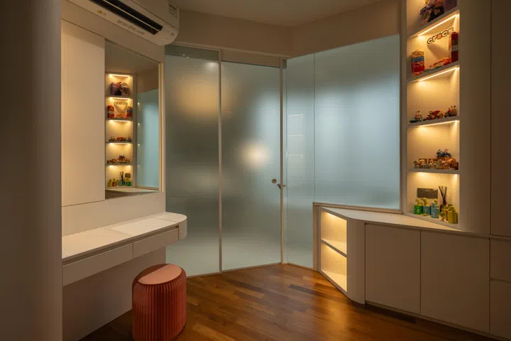 A concealed vanity with lift-up storage and sliding mirror keeps daily routines discreet, revealing a painting when slid.