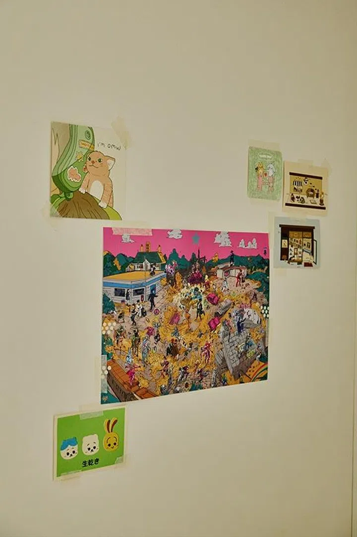 Collected postcards taped directly onto the wall create an informal gallery — personal, playful and easy to update.