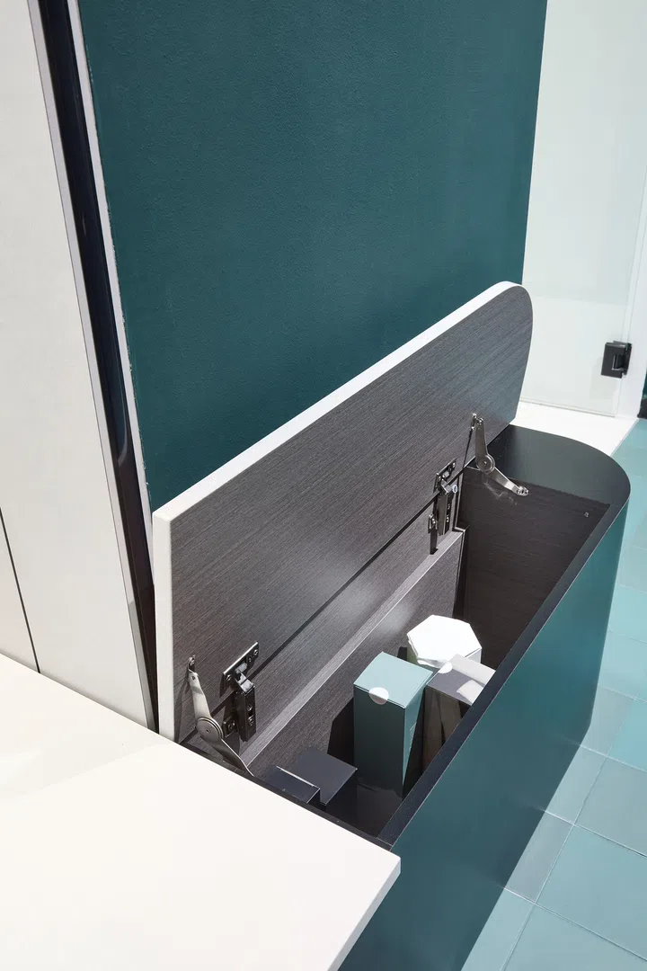 A built-in bench with concealed storage, opened to reveal its dual-purpose function.